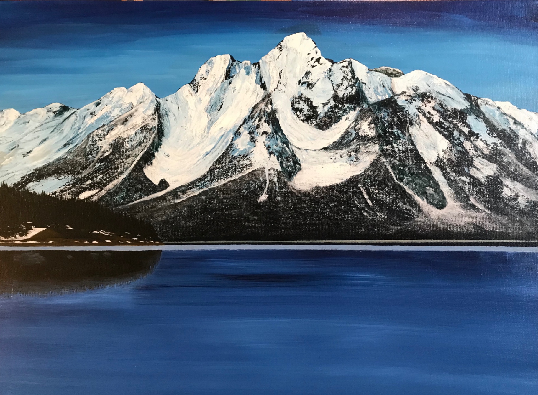 Snow-capped mountain over still water